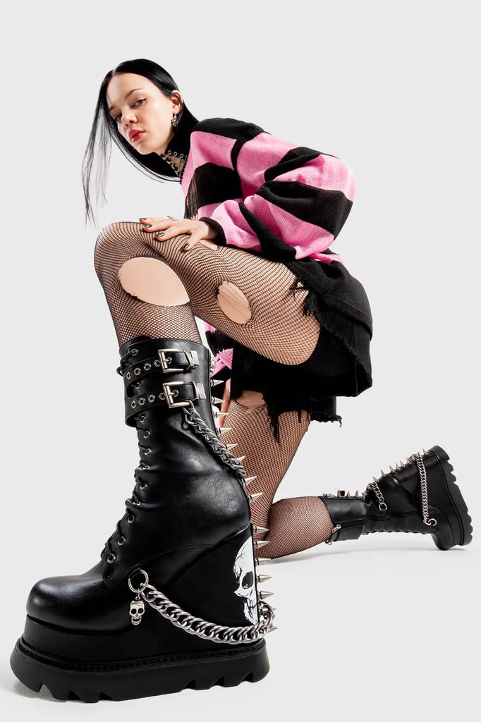 Creating Chaos
 
 She's Dangerous Chunky Platform Ankle Boots in Black faux leather. These Black vegan Wedge boots feature a skull print on our Platform wedge sole, with chains, buckles and spikes on the boots, perfect for adding height and edge to any look. Made with eco-friendly materials and 100% cruelty-free.
 
 
 - Platform Height: 
 - Heel Height
 - Silver Buckles
 - Silver Chains
 - Skull print
 - Spikes
 - Black Zip
 - Wedge sole
 - Round Toe
 - 100% vegan 
 
 SKU: LMF 2946 - Black/Skull