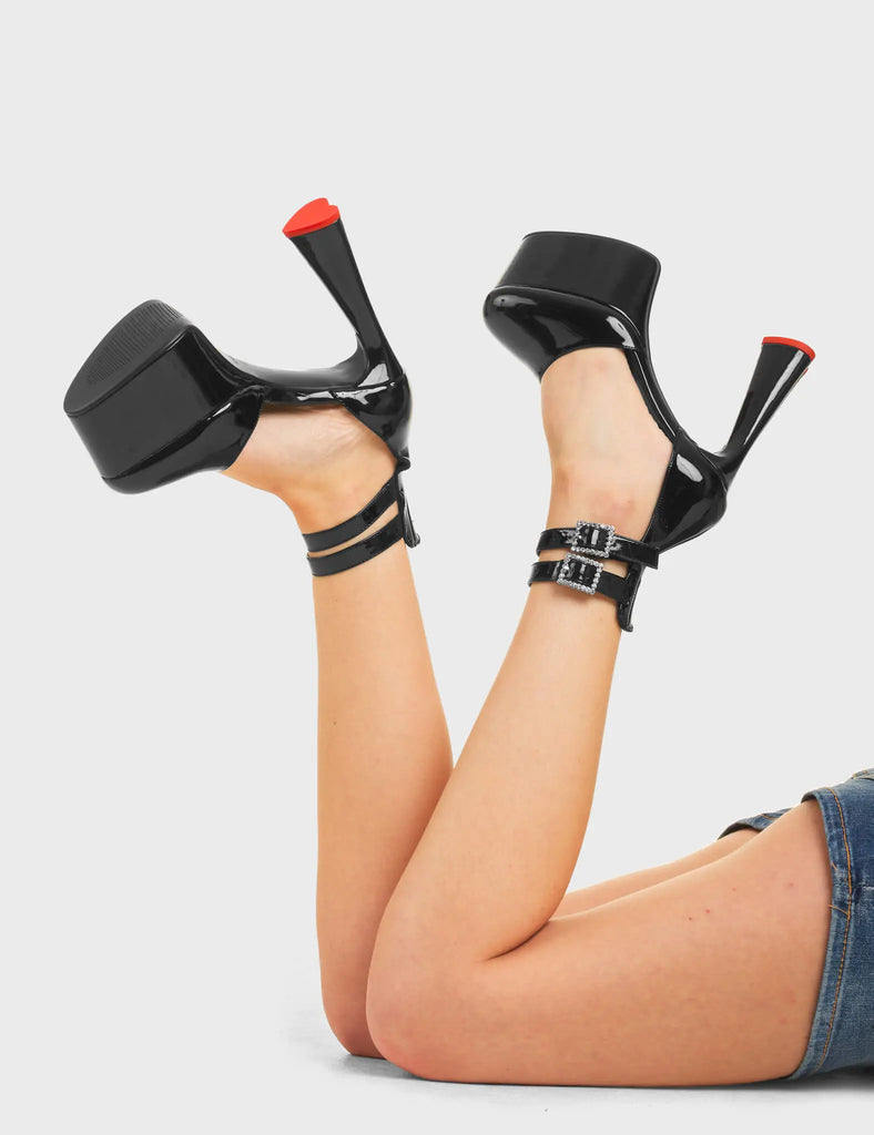 BLINDING

Shine On Platform Heels in Black Patent. These platform heels feature two adjustable black straps across the upper with black eyelets and studded square shaped buckles, Also features a heart shaped heel with a red heart at the bottom. let your shoes shine. Made with eco-friendly materials and 100% cruelty-free

- Platform Height
- Heel Height
- Two adjustable black ankle straps
- Studded square shaped buckle
- Black eyelets
- Platform sole
- Round Toe
- 100% vegan

SKU: LMF 4465 - BlackPAT