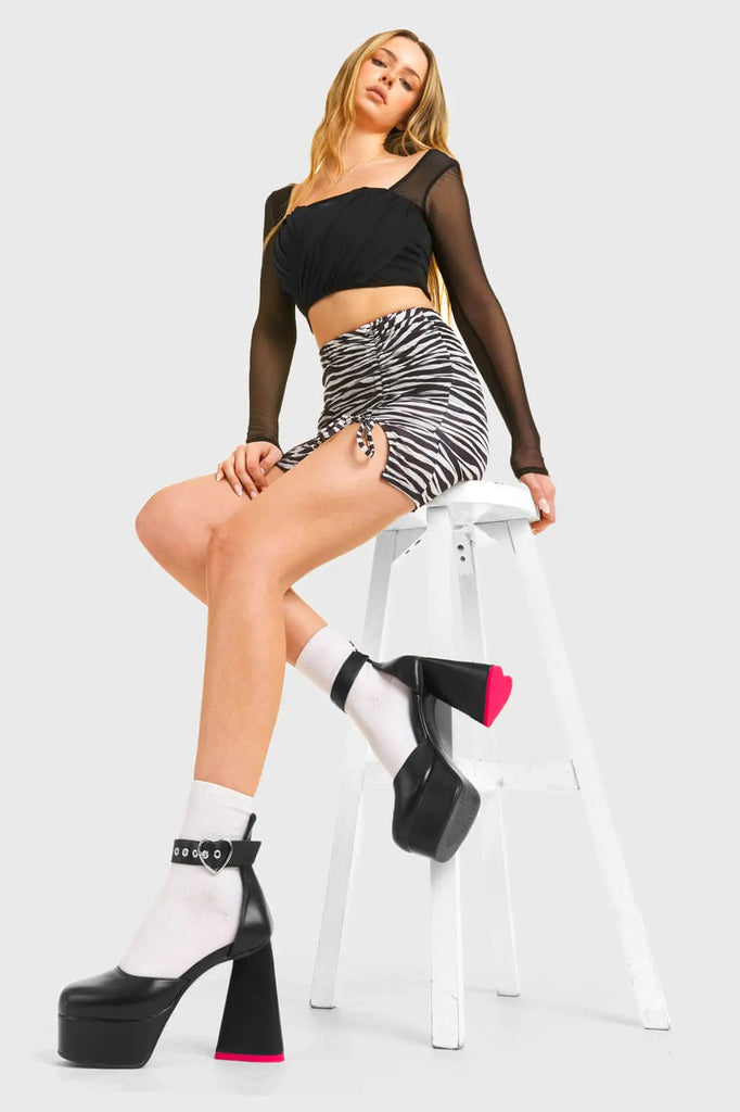 IN MY HEART AND MIND
 
 Sole Mate Platform Heels in Black faux leather. These platform boots feature a sliver heart buckle and a heart shaped heel, keeping it nice and classy. Made with eco-friendly materials and 100% cruelty-free, these platform boots are as ethical as they are chic.
 
 - Platform Height
 - Silver heart buckle
 - Adjustable straps
 - Pink sole
 - Shark teeth grip
 - heart shaped heel
 - High Heel
 - 100% vegan 
 
 SKU: LMF 3475 - BlackPU