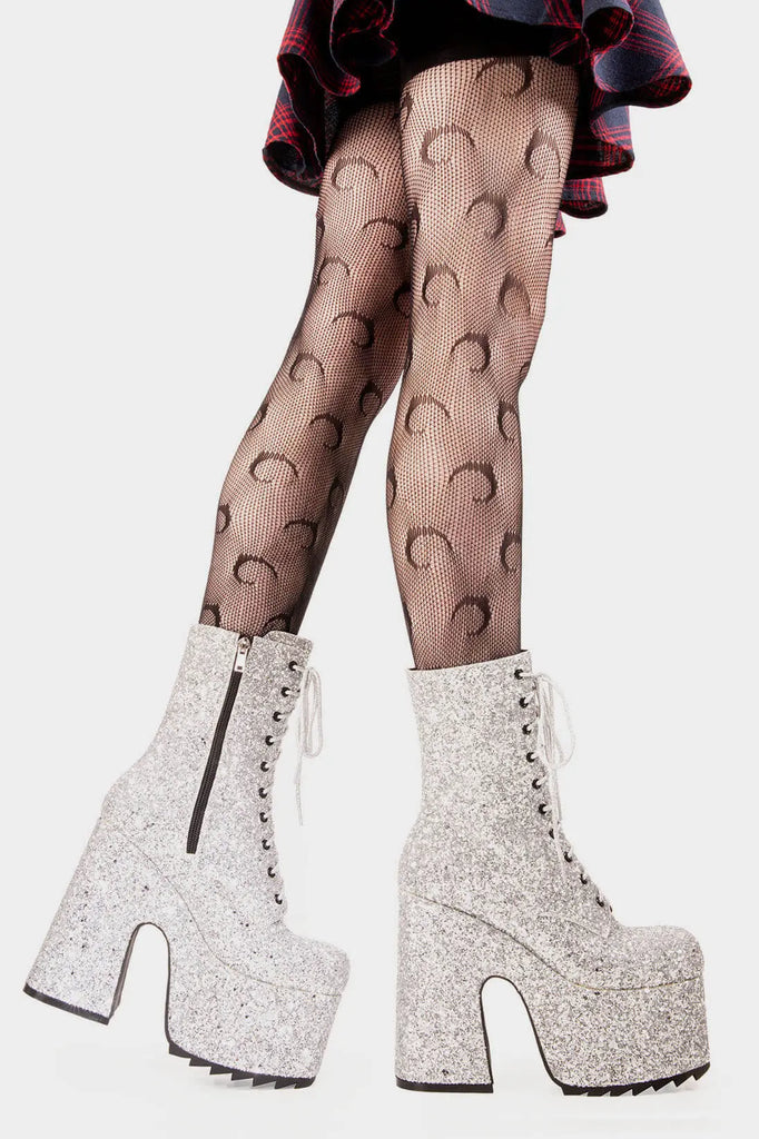Dazzling Delights
  
 Spotlight Chunky Platform Ankle Creeper Boot in Silver Glitter. These silver vegan Platform Boots feature our iconic glitter detail througout with adjustable lace up detail, shiny perfection to glow with every step. Made with eco-friendly materials and 100% cruelty-free.
 
 
 - Platform Height
 - Heel Height 
 - Black zipper 
 - Silver laces and silver eyelets 
 - Chunky Creeper sole
 - Round Toe
 - 100% vegan 
 
 SKU: LMF 2046 - SilverGlitter