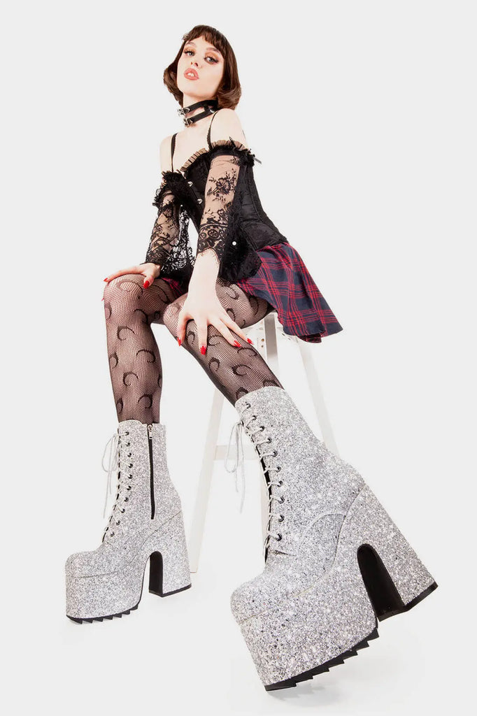 Dazzling Delights
  
 Spotlight Chunky Platform Ankle Creeper Boot in Silver Glitter. These silver vegan Platform Boots feature our iconic glitter detail througout with adjustable lace up detail, shiny perfection to glow with every step. Made with eco-friendly materials and 100% cruelty-free.
 
 
 - Platform Height
 - Heel Height 
 - Black zipper 
 - Silver laces and silver eyelets 
 - Chunky Creeper sole
 - Round Toe
 - 100% vegan 
 
 SKU: LMF 2046 - SilverGlitter