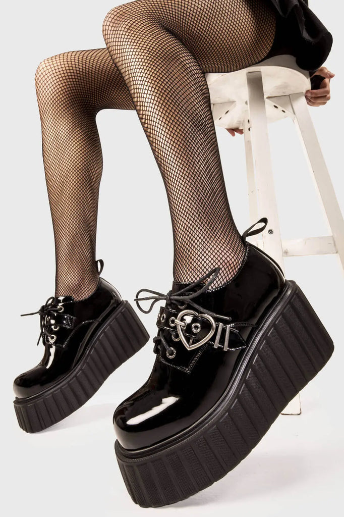 Sweetheart Steps
 
 Stick To It Chunky Platform Creeper Shoes in Black Patent faux leather. These black creeper shoes feature an adjustable black lace up detail with silver eyelets and a adjustable black strap across the upper with heart shaped buckle, leaving a trail of love with every step.
 
 - Platform Height
 - Black Laces with black eyelets
 - Black strap
 - Heart shaped buckle
 - Chunky creeper wedge sole
 - Round Toe 
 - 100% vegan