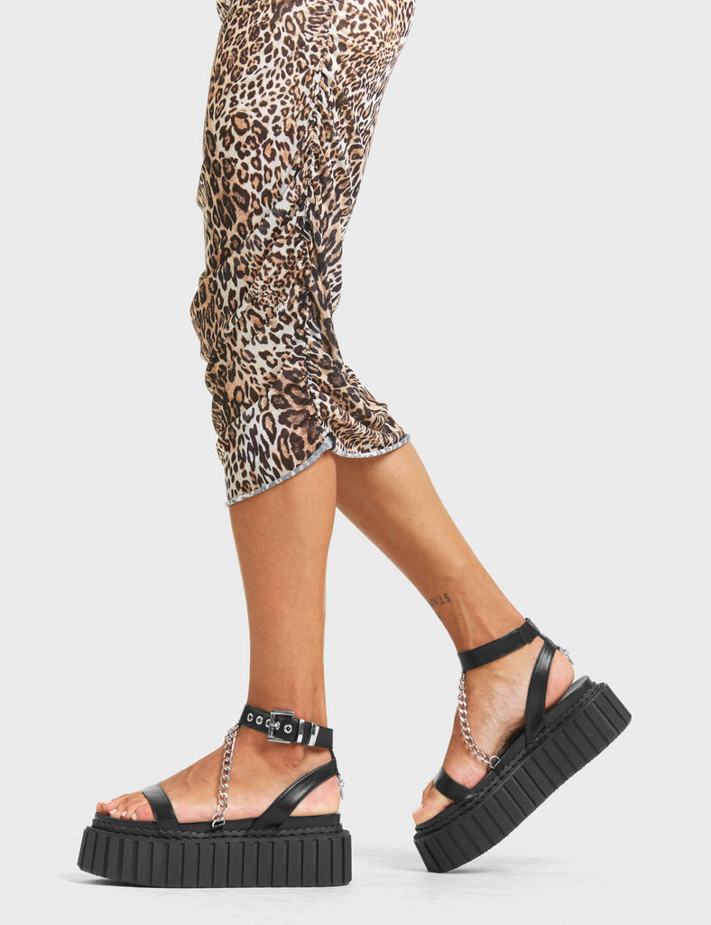 VACATION VIBES

Sun Tan Chunky Platform Creeper Sandals in Black faux leather. These creeper sandals feature a strap design, including a adjustable strap across the ankle, with silver eyelets and a square shaped buckle. Also incldues a aesthetic sliver chain. Made with eco-friendly materials and 100% cruelty-free, these sandals are as ethical as they are edgy

- Platform Height
- Silver Eyelets
- Square Shaped Buckles
- Silver Chain
- Platform Creeper Sole
- Open Toe
- 100% vegan

SKU: LMF 4405 - BlackPU