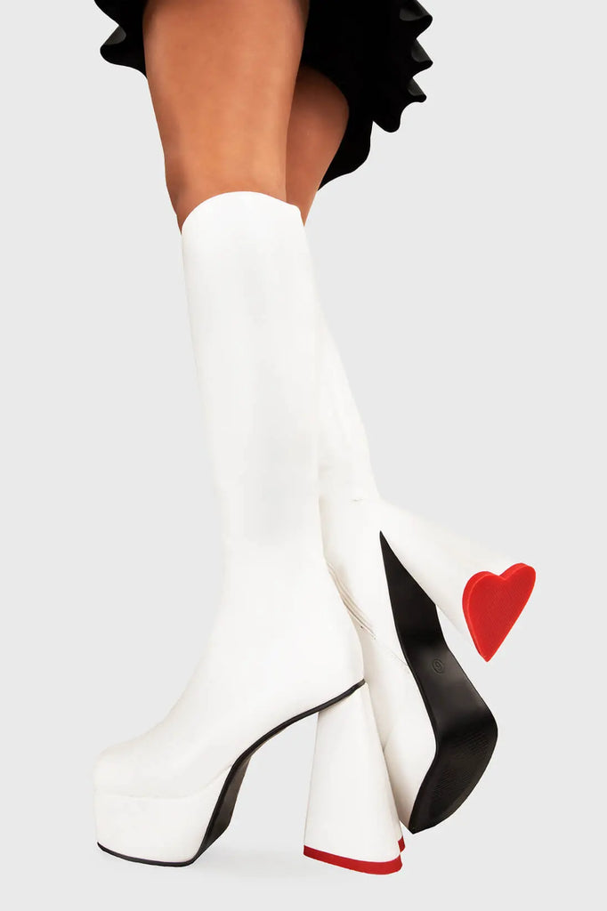 LOVEABLE 
 
 Sweet Talker Wide Calf Platform Knee High Boots in white faux leather. These platform boots feature a minimalist look with a heart shaped heel, keeping it nice and classy. Made with eco-friendly materials and 100% cruelty-free, these platform boots are as ethical as they are chic.
 
 - Platform Height
 - Knee length
 - Heart shaped heel
 - Red sole
 - Wide calf 
 - White zip
 - High Heel
 - 100% vegan 
 
 SKU: LMF 3313 - WhitePU - WIDE FIT