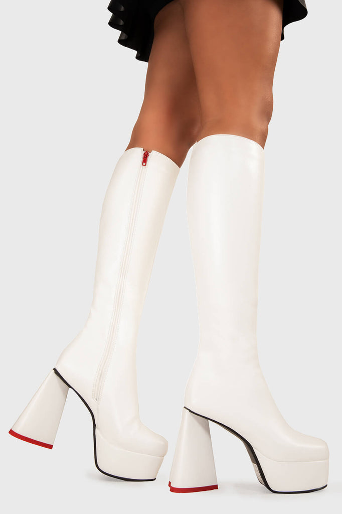 LOVEABLE 
 
 Sweet Talker Platform Knee High Boots in White faux leather. These platform boots feature a minimalist look with a heart shaped heel, keeping it nice and classy. Made with eco-friendly materials and 100% cruelty-free, these platform boots are as ethical as they are chic.
 
 - Platform Height
 - Knee length
 - Heart shaped heel
 - Red sole
 - White zip
 - High Heel
 - 100% vegan 
 
 SKU: LMF 3313 - WhitePU