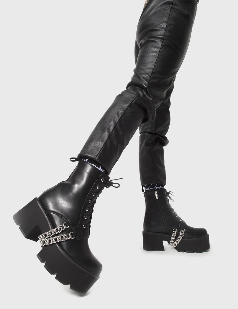 COMFY DRIP'
 
 Trapped Chunky Platform Ankle Boots in Black faux leather. These vegan Platform Ankle Boots feature hanging silver chains and our CHUNKY Platform sole, making them the perfect comfy Boots with a little extra! Made with eco-friendly materials and 100% cruelty-free, these boots are as ethical as they are special!
 
 
 - Platform Height: 3 inch
 - Mid ankle length 
 - Black zipper
 - Lace up
 - Black pull tab
 - Cunky Platform sole
 - Round toe 
 - 100% vegan 
 
 SKU: LMF 0173 - BlackPU