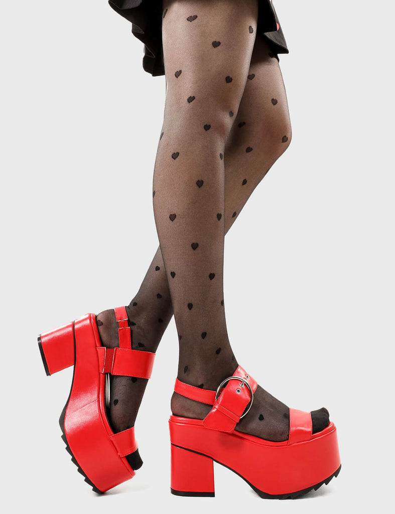 Summer Steps
 
 Trapped In The Sun Chunky Platform Sandals in Red faux leather. These platform sandals feature an adjustable strap across the upper with silver eyelets and D shaped buckle, embrace the summer and make hot statments. Made with eco-friendly materials and 100% cruelty-free, these platform boots are as ethical as they are HOT!
 
 - Platform Height
 - Heel Height
 - Adjustable red strap
 - Silver eyelets with D shaped buckle
 - Chunky Platform sole
 - Shark's teeth grip
 - Round Toe