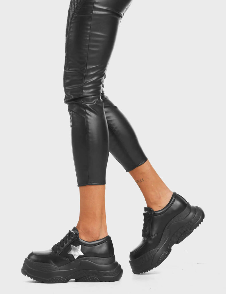 Venus Chunky Platform Sneakers in Black. Feature black lace-up fastening and a silver star.