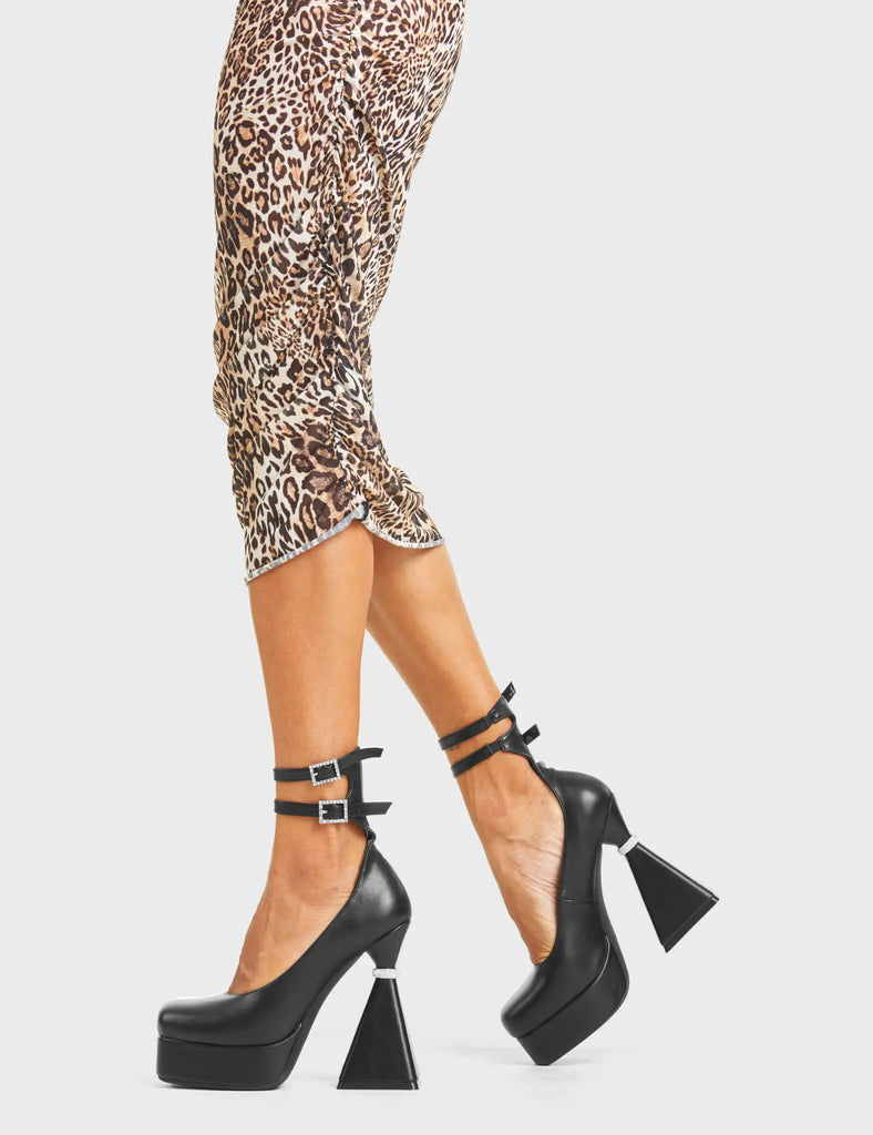 WONDERING 
 
 What Is Love Platform Heels in black faux leather. These platform heels feature a flared heel that includes silver studded ring detailing on the heel, keeping it nice and classy. These heels also feature two adjustable straps with silver studded buckles and silver eyelets. Made with 100% vegan materials.
 
 - Platform Height
 - Flared Heel
 - Studded Detail
 - Silver Eyelets
 - Silver Ring
 - Two Adjustable Strap
 - Silver Studded Buckles
 - 100% Vegan
 
 SKU: LMF 4876 - BlackPU