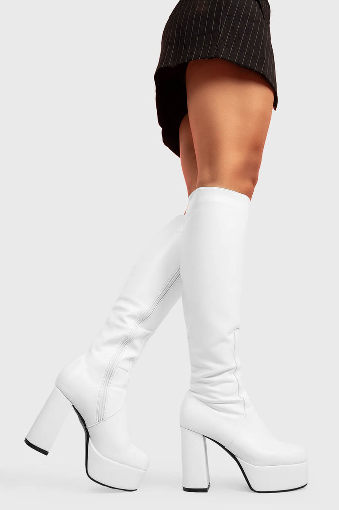 THE TIMELESS ONE
 
 Whatta Showdown Platform Knee High Boots in White faux leather. These White vegan Boots feature an elegant, minimalist design and a Platform sole and heel, perfect for adding height and style to any outfit. Made with eco-friendly materials and 100% cruelty-free, these boots are as ethical as they are stylish.
 
 
 - Platform Height: 1.25 inch
 - Heel Height: 4.2 inch
 - Knee High length
 - White zipper 
 - Platform sole
 - Round toe 
 - 100% vegan 
 
 SKU: LMF 0916 - WhitePU